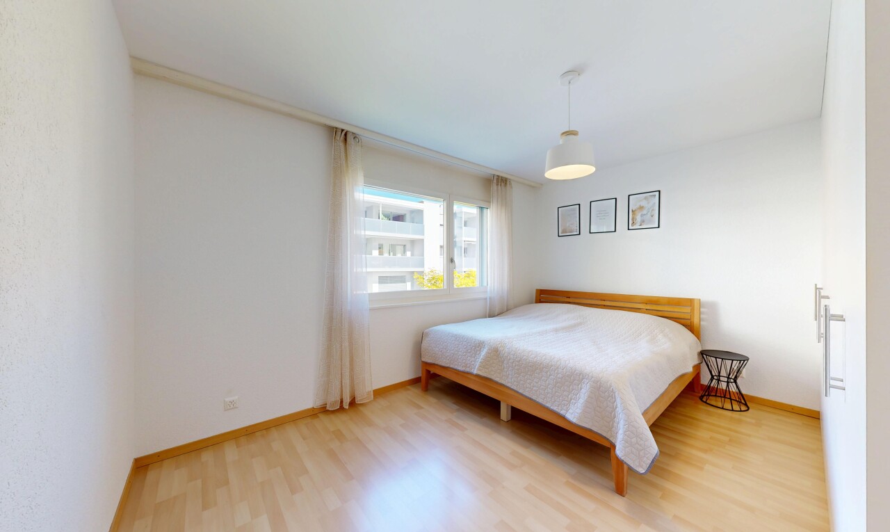 room / bedroom featuring light wood finished floors and baseboards