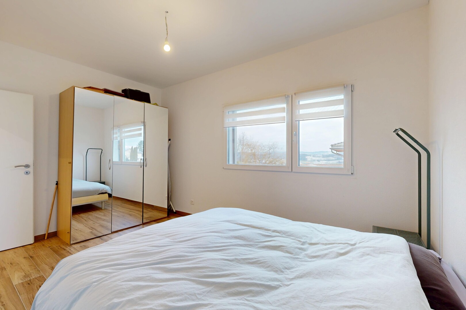 room / bedroom with light wood-style flooring and a closet