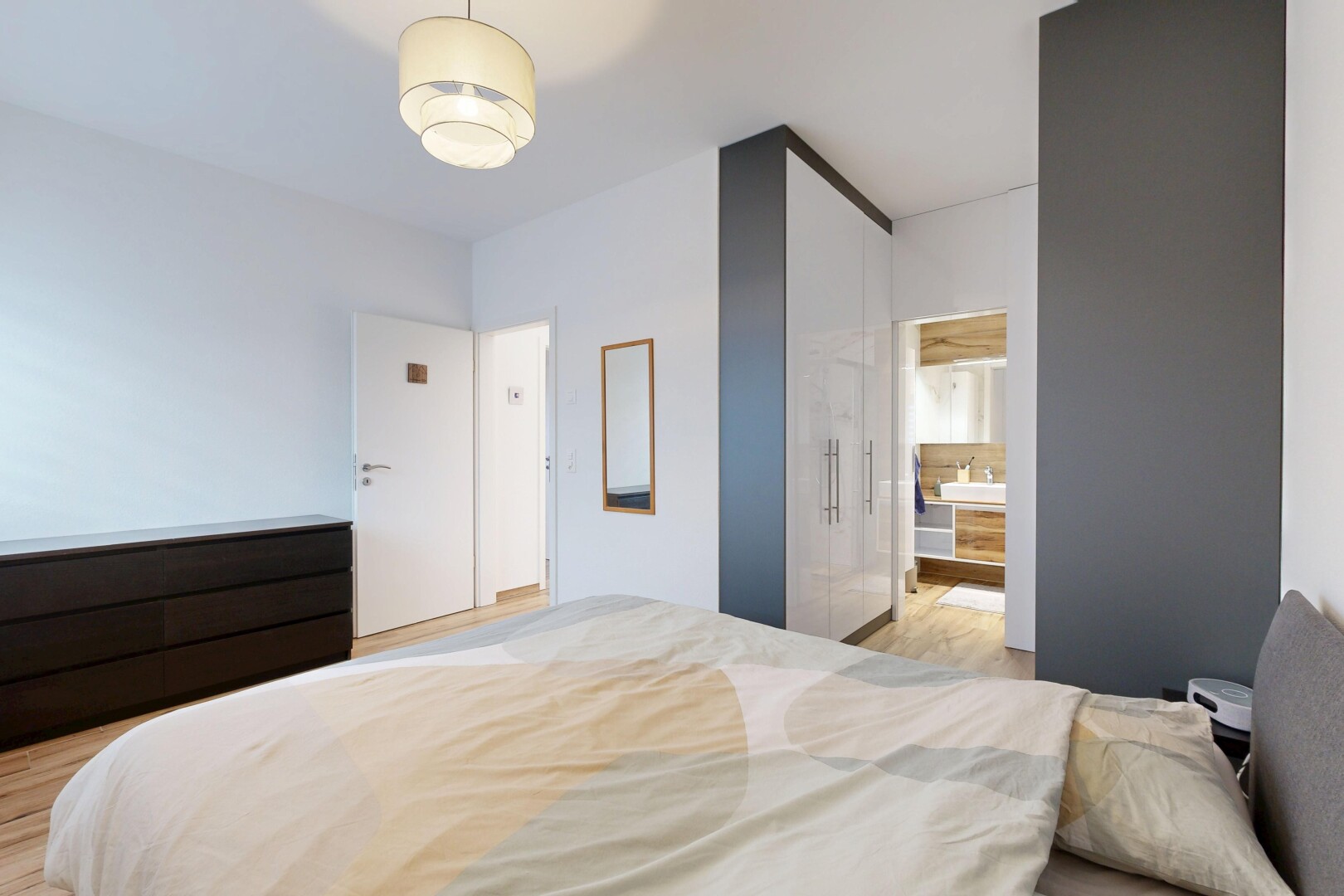 room featuring light wood-style floors and ensuite bath