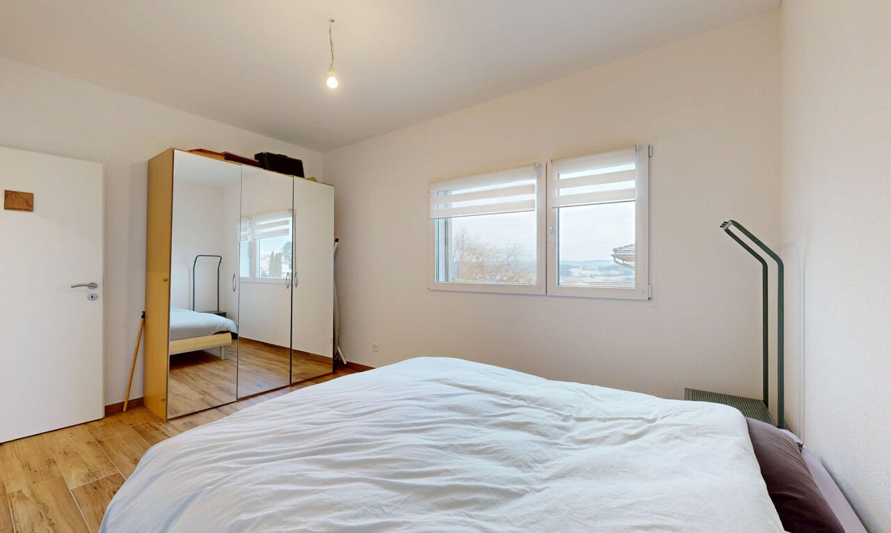 room / bedroom with light wood-style flooring and a closet