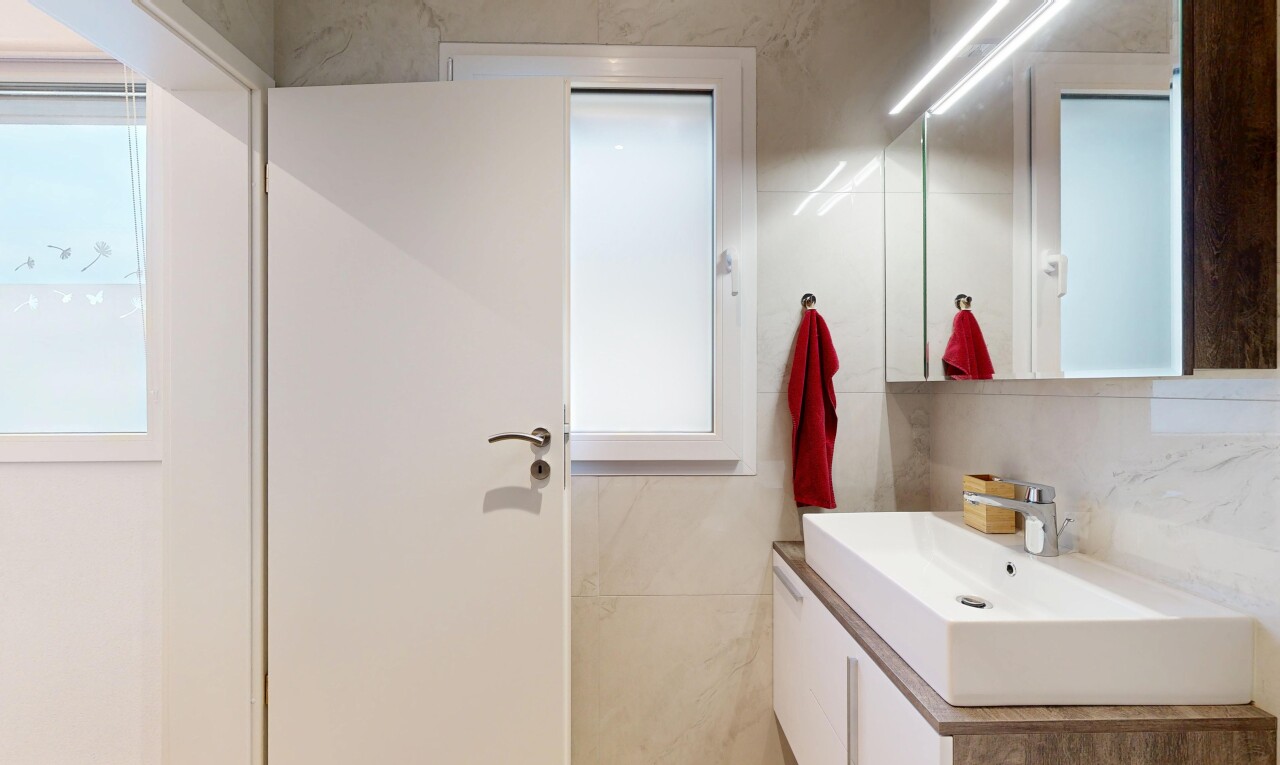 bathroom with vanity, tasteful backsplash, and tile walls