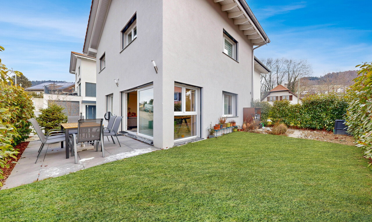 outdoor house featuring a yard, a patio, and stucco siding
