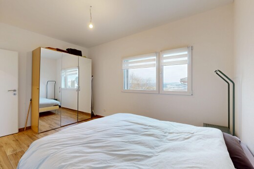room / bedroom with light wood-style flooring and a closet