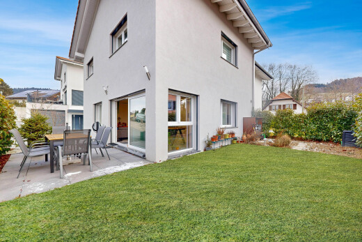 outdoor house featuring a yard, a patio, and stucco siding