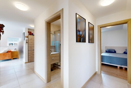 hallway with light tile patterned floors and baseboards