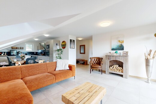 living area with a premium fireplace and lofted ceiling