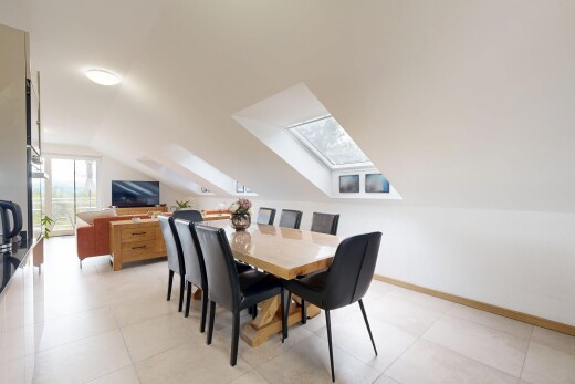 dining space featuring a skylight and vaulted ceiling