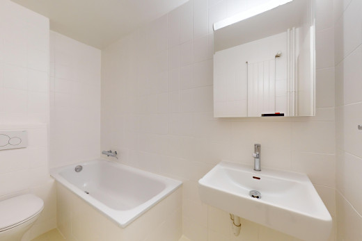 bad mit fliesenwand und toilette