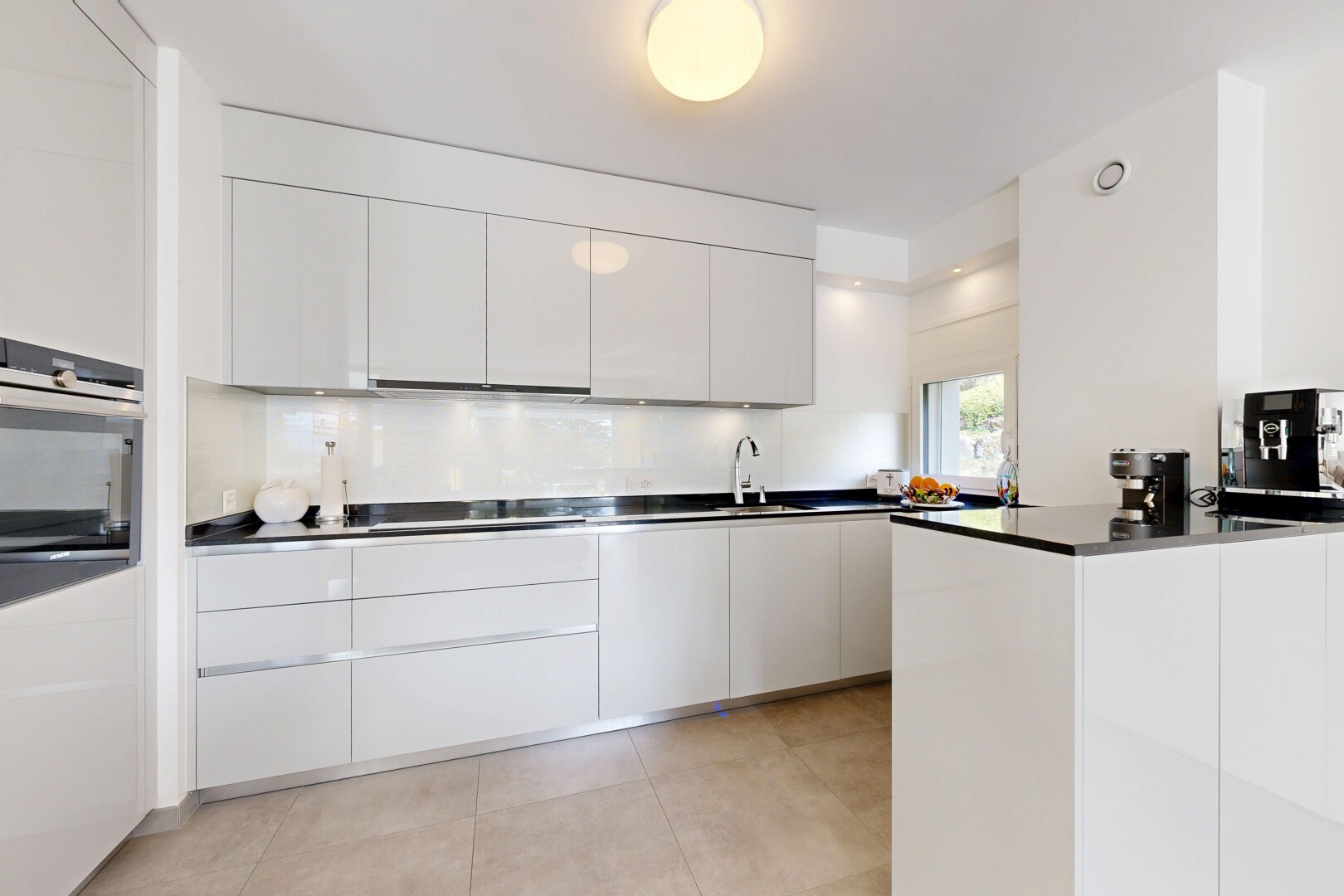kitchen with modern cabinets, white cabinets, stainless steel appliances, and dark countertops