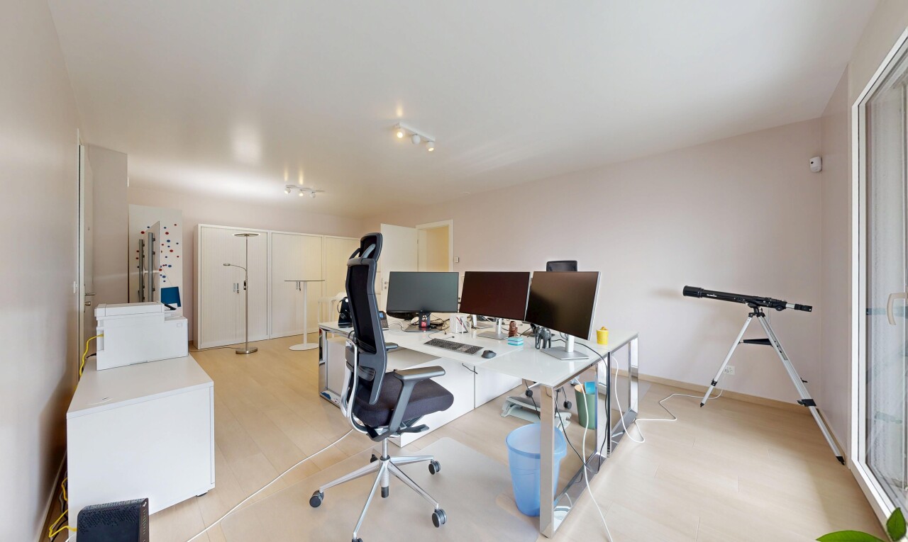 office featuring light wood-type flooring and track lighting
