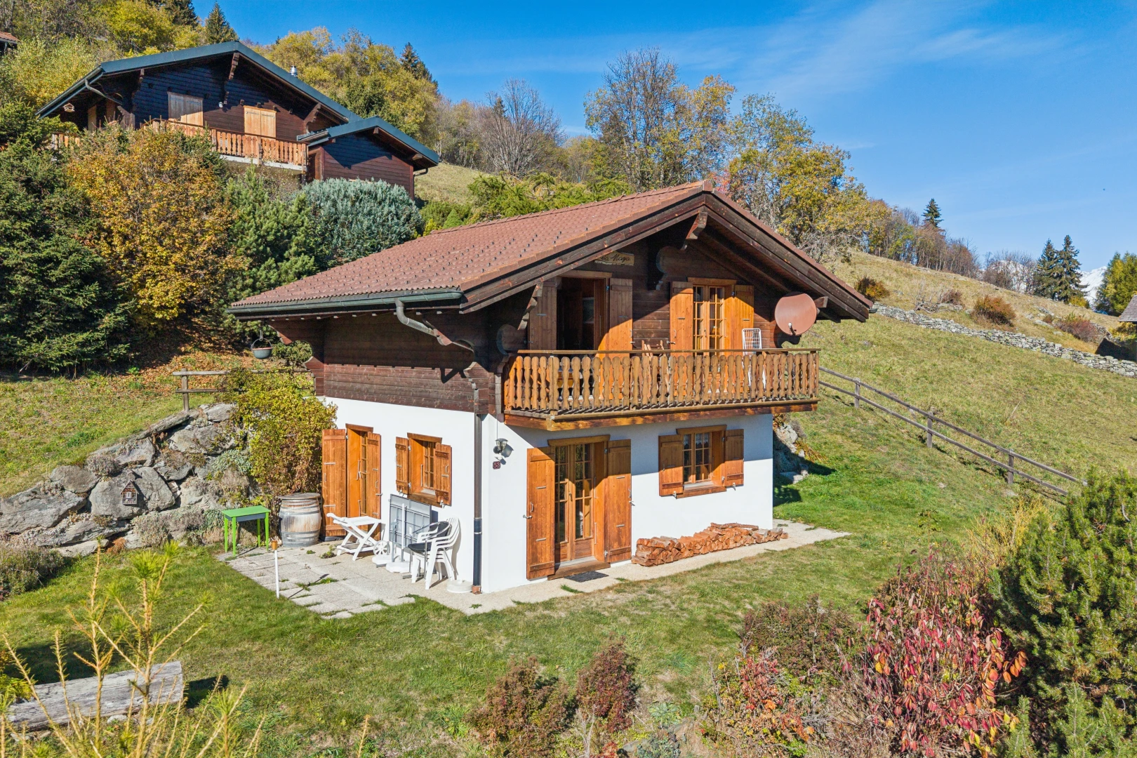 view of property with a lawn, a balcony, and a patio
