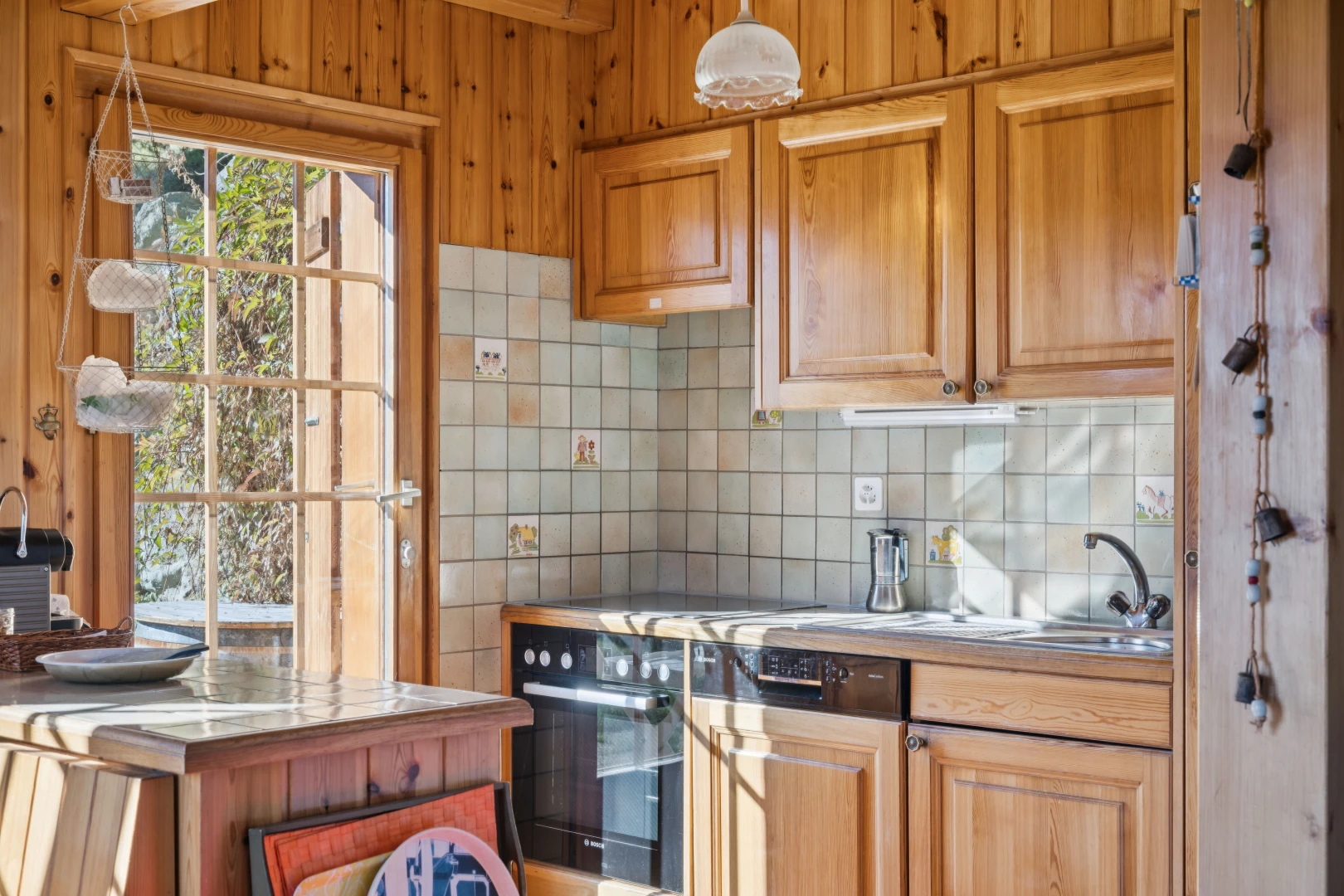 kitchen with decorative backsplash, light countertops, and oven
