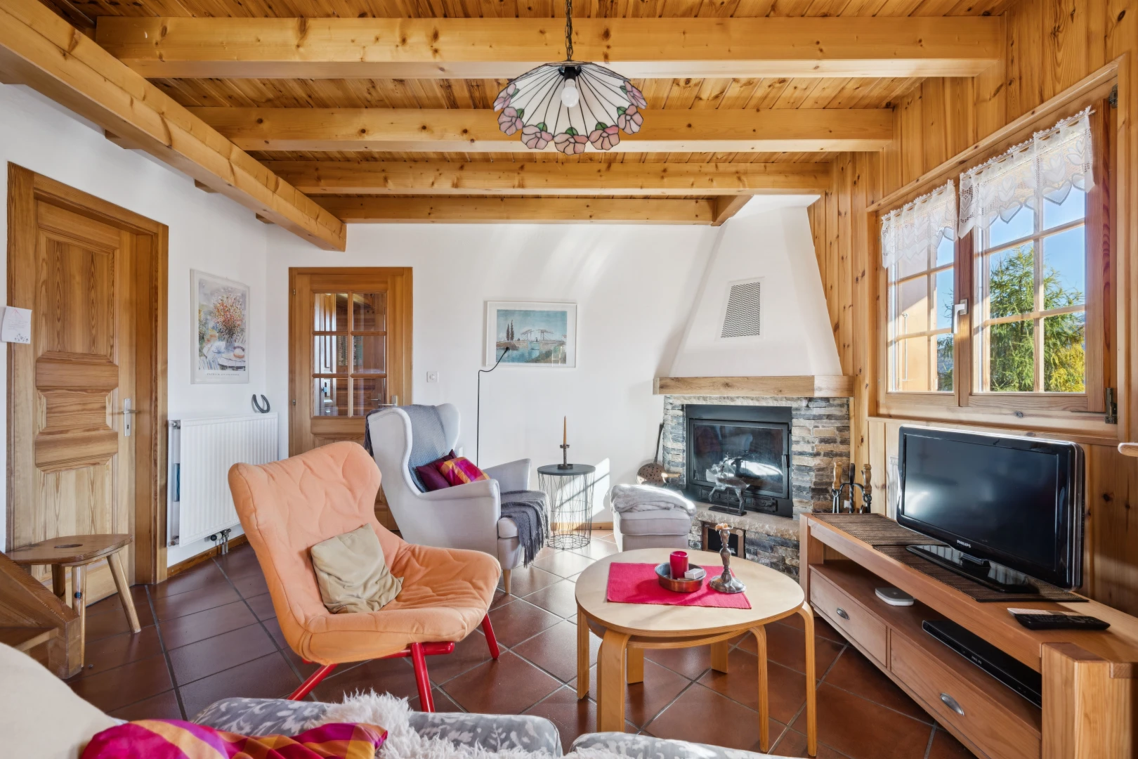 living area featuring a fireplace, a wood ceiling with exposed beams, radiator, and dark tile patterned floors