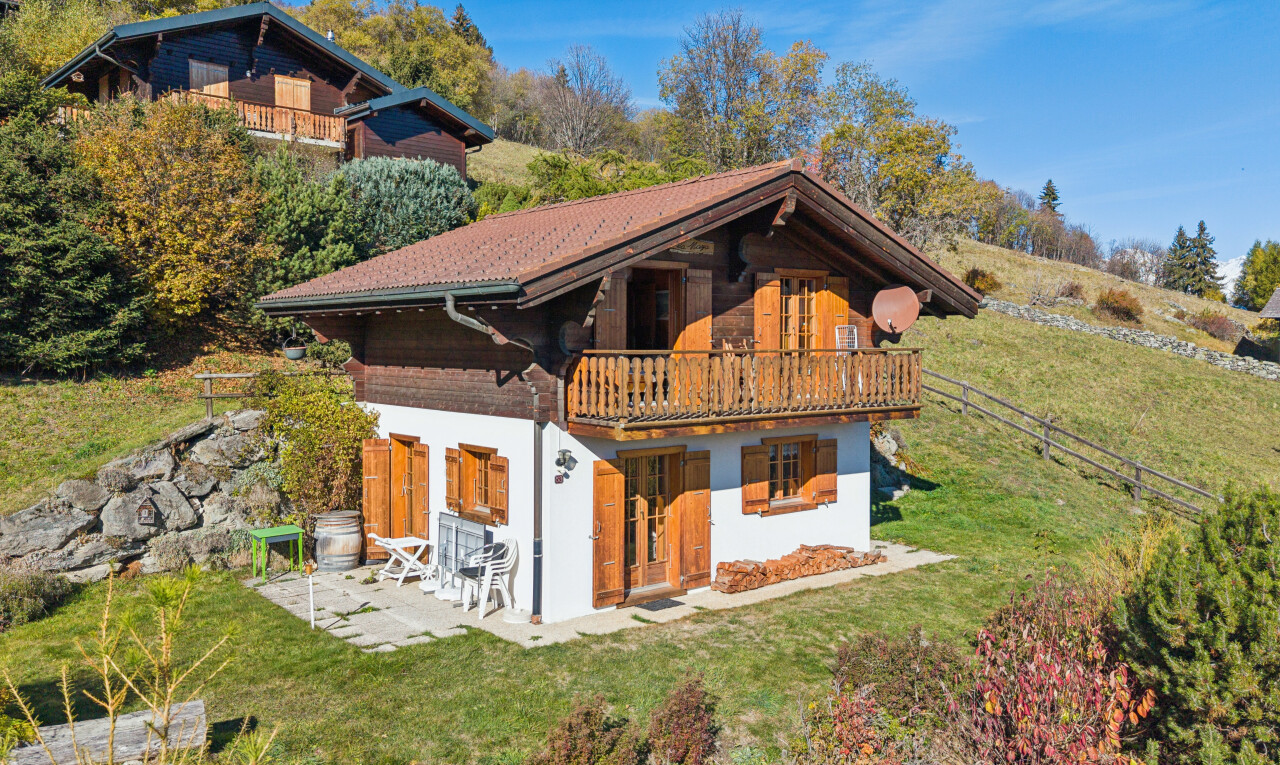 view of property with a lawn, a balcony, and a patio