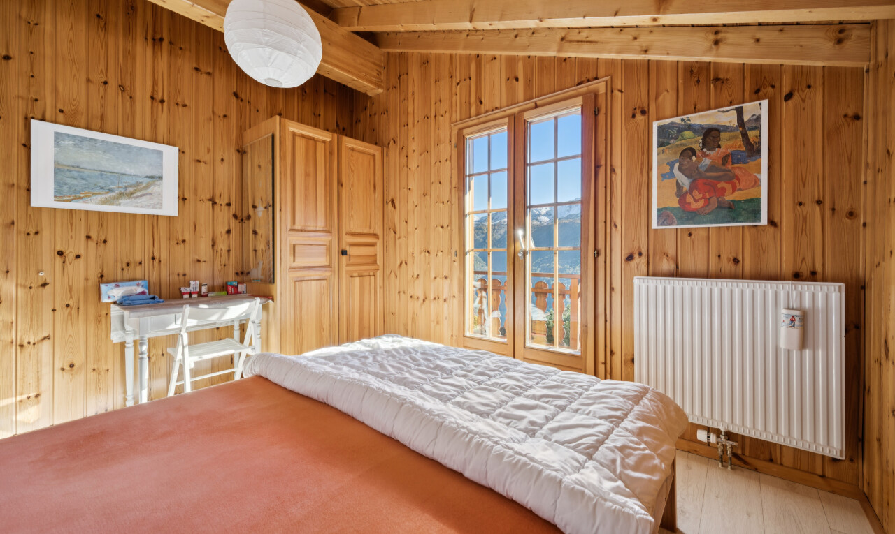 room with radiator heating unit, light wood-style floors, wooden ceiling, wood walls, and vaulted ceiling with beams