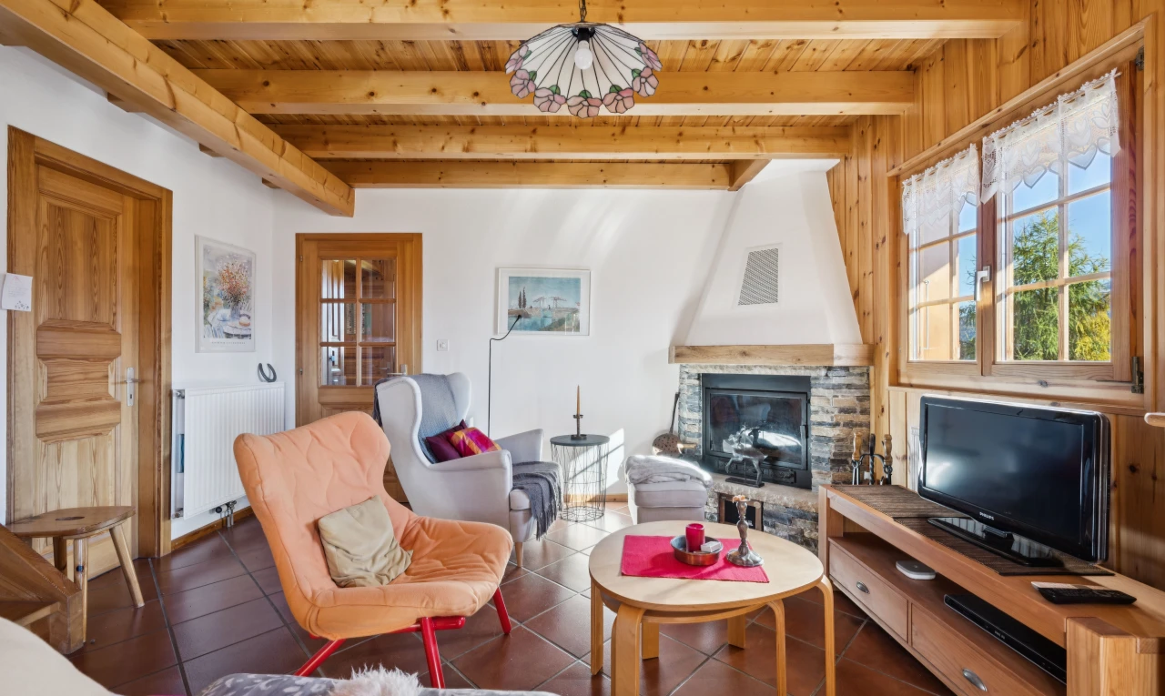 living area featuring a fireplace, a wood ceiling with exposed beams, radiator, and dark tile patterned floors
