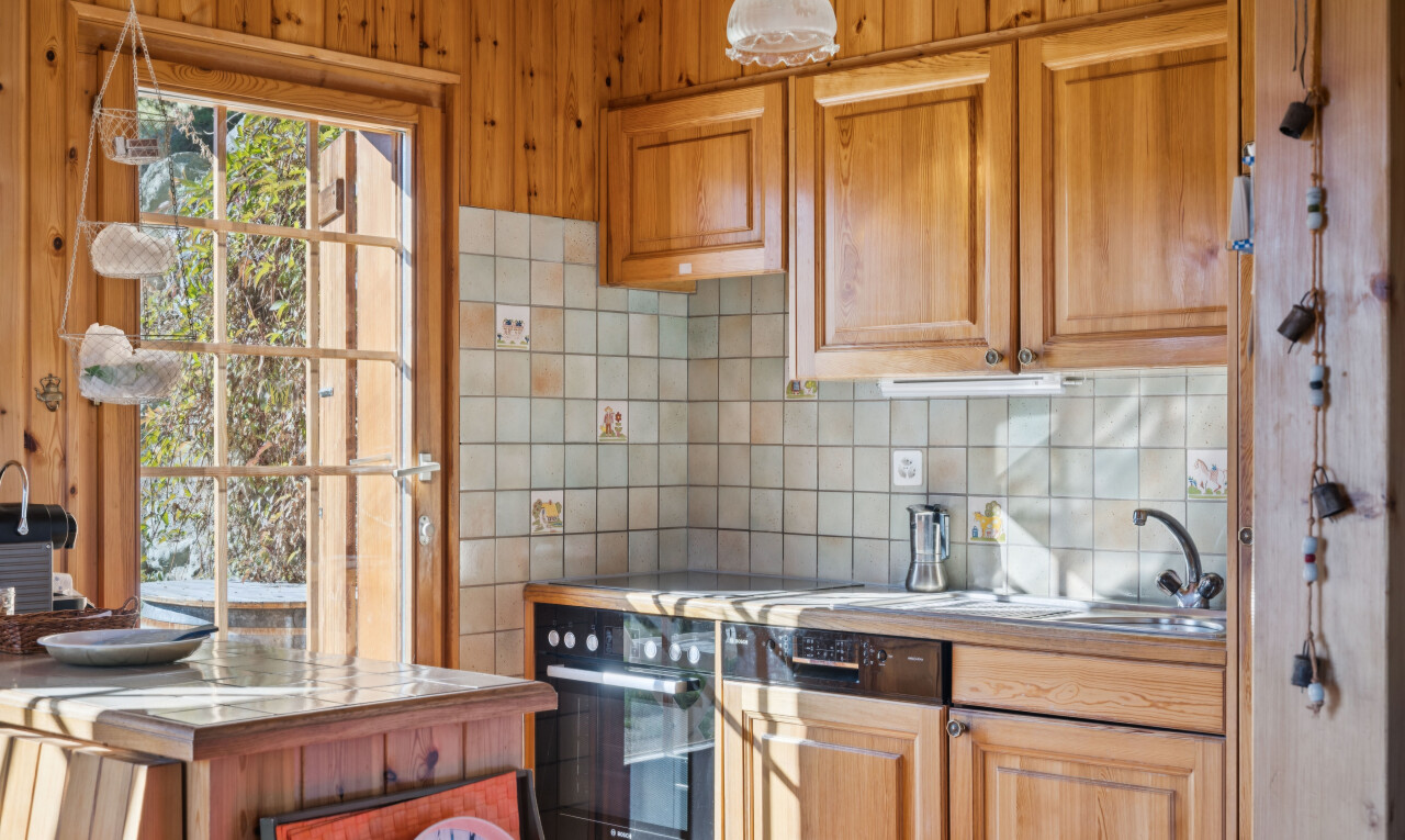 kitchen with decorative backsplash, light countertops, and oven