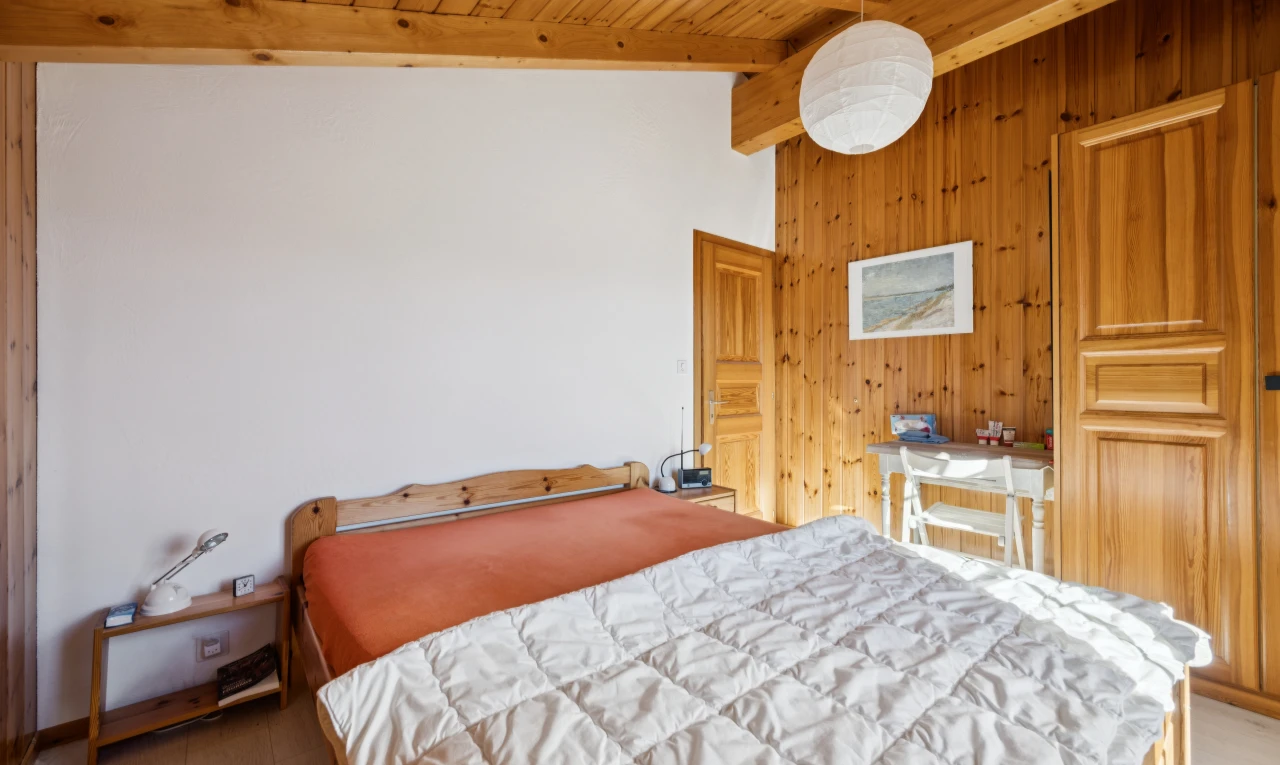 room featuring wooden walls, vaulted ceiling with beams, wood ceiling, hanging light fixtures, and light wood-type flooring