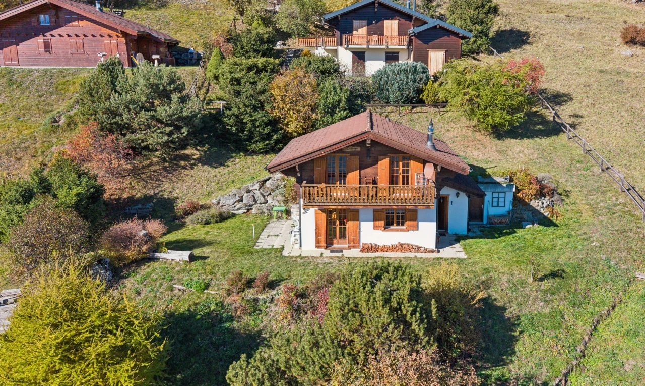 view of home featuring a yard and a balcony