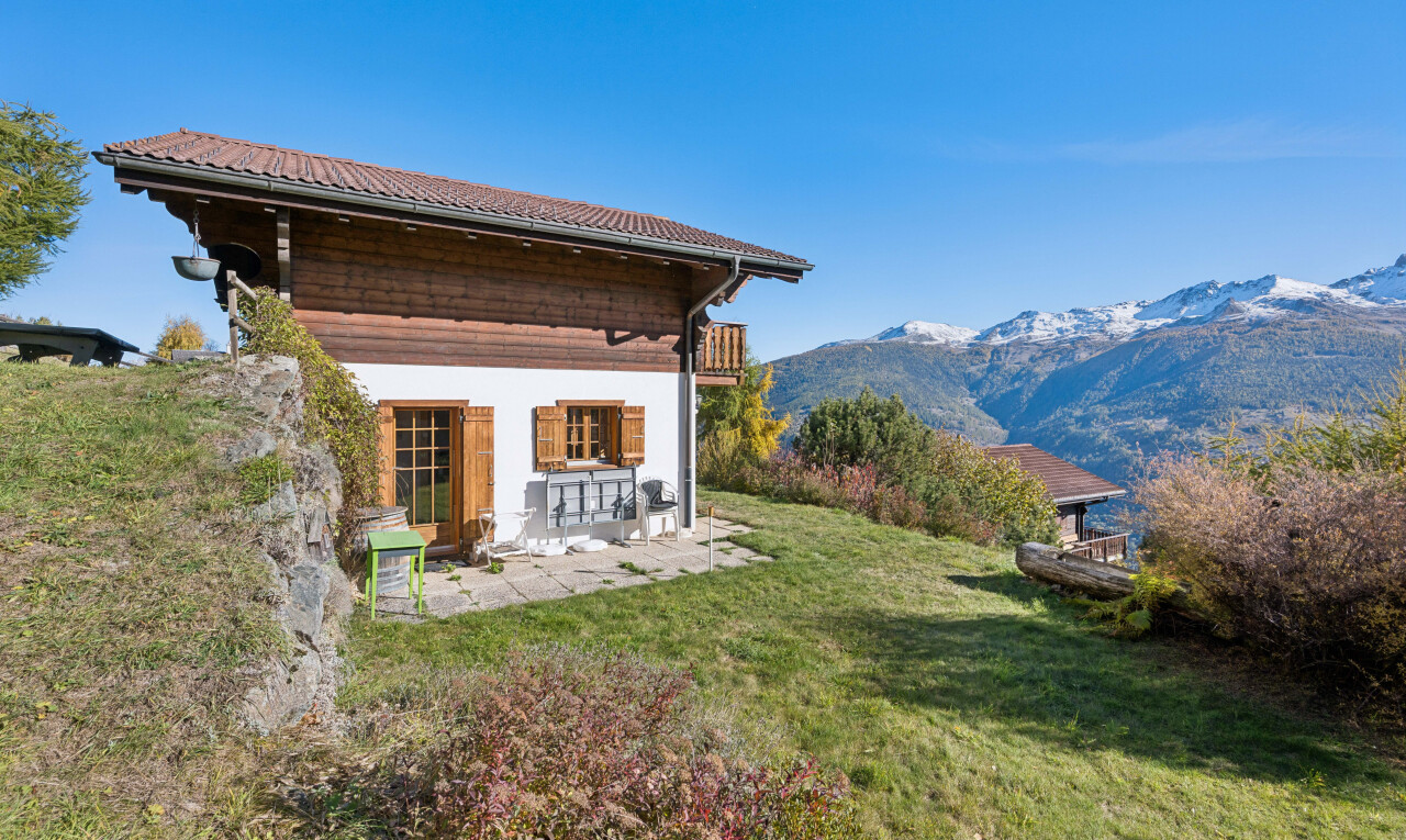 view of property featuring a yard, a mountain view, a patio, and a balcony