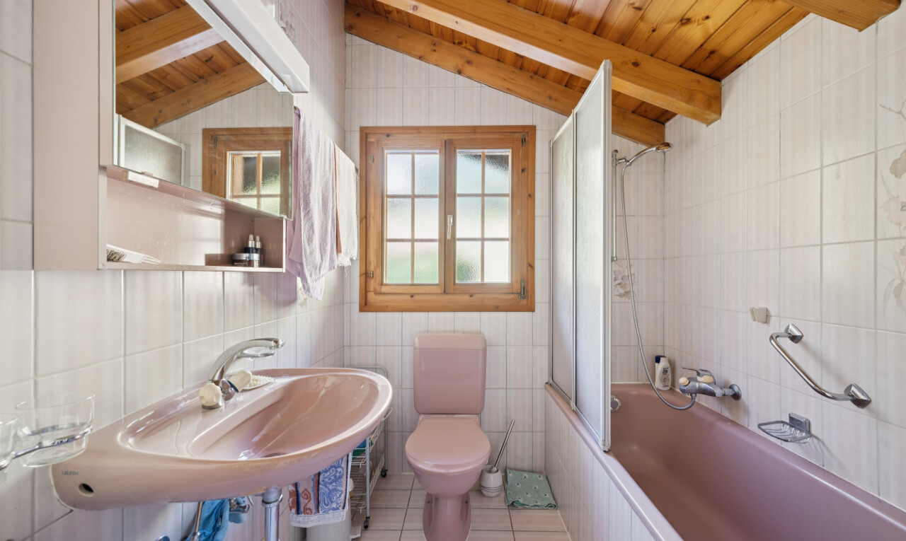 bathroom with tile walls, tiled shower / bath, wood ceiling, light tile patterned floors, and vaulted ceiling with beams