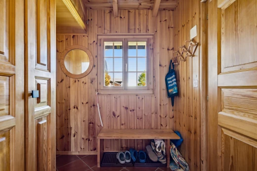 hallway with wooden walls and dark tile patterned floors