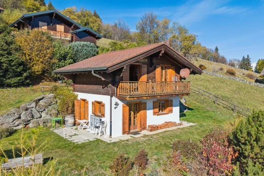 view of property with a lawn, a balcony, and a patio