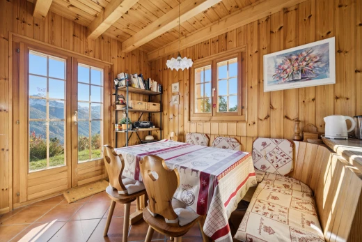 dining area featuring wooden walls, a wood ceiling with exposed beams, a mountain view, french doors, and tile patterned flooring