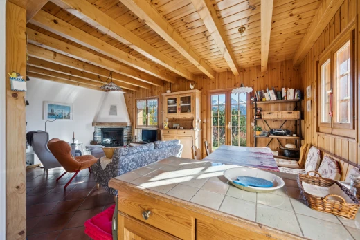 dining space featuring a wood ceiling with exposed beams, french doors, a fireplace, access to exterior, and wood walls