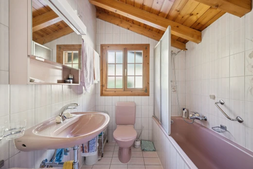 bathroom with tile walls, tiled shower / bath, wood ceiling, light tile patterned floors, and vaulted ceiling with beams
