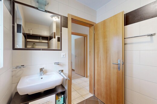 half bathroom featuring tile walls and light tile patterned flooring