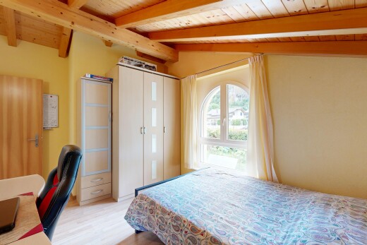 room / bedroom featuring light wood-style flooring, wooden ceiling, vaulted ceiling with beams, and a desk