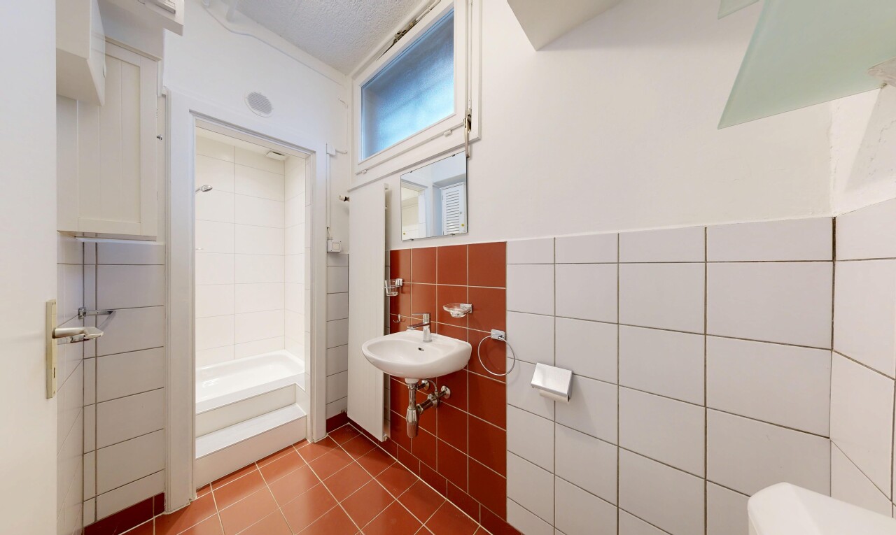 salle de bains avec salle de bain complète, miroir, inside property, évier, et tile wall