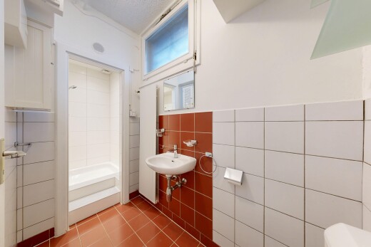bathroom with tile walls, tile patterned floors, and bathtub / shower combination
