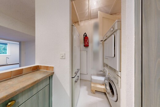 full bathroom with stacked washing machine and dryer, a textured wall, and shower / washtub combination