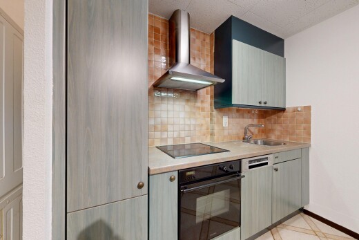 kitchen featuring black appliances, light countertops, backsplash, and gray cabinets