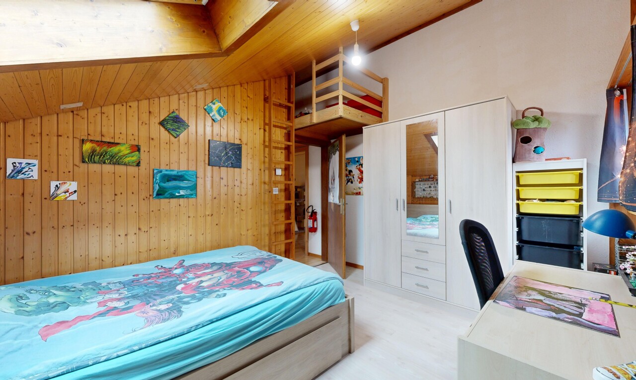 chambre avec plafond voûté, vaulted ceiling, inside property, mur en bois, et wood wall
