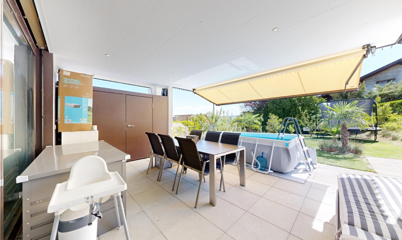 terrasse avec coin repas extérieur, rampe, et piscine