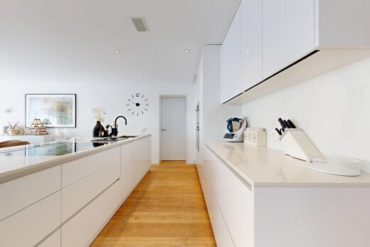 cuisine avec flat panel cabinets, armoires à panneau plat, white cabinets, armoires blanches, et light countertops