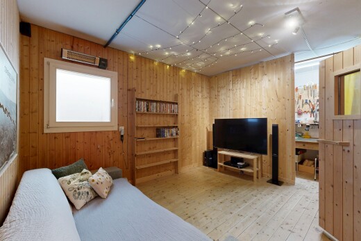 living room featuring light wood finished floors and wood walls
