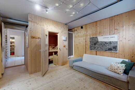living area featuring light wood-type flooring and wooden walls