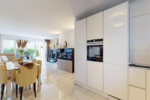 kitchen featuring oven, modern cabinets, open floor plan, and white cabinets