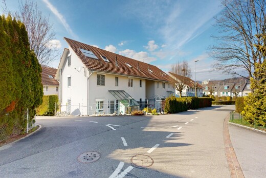 view of home with a residential view, stucco siding, and uncovered parking