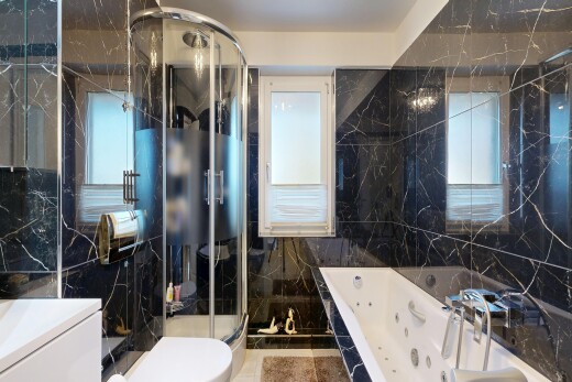full bathroom with tile walls, a marble finish shower, vanity, and a tub with jets