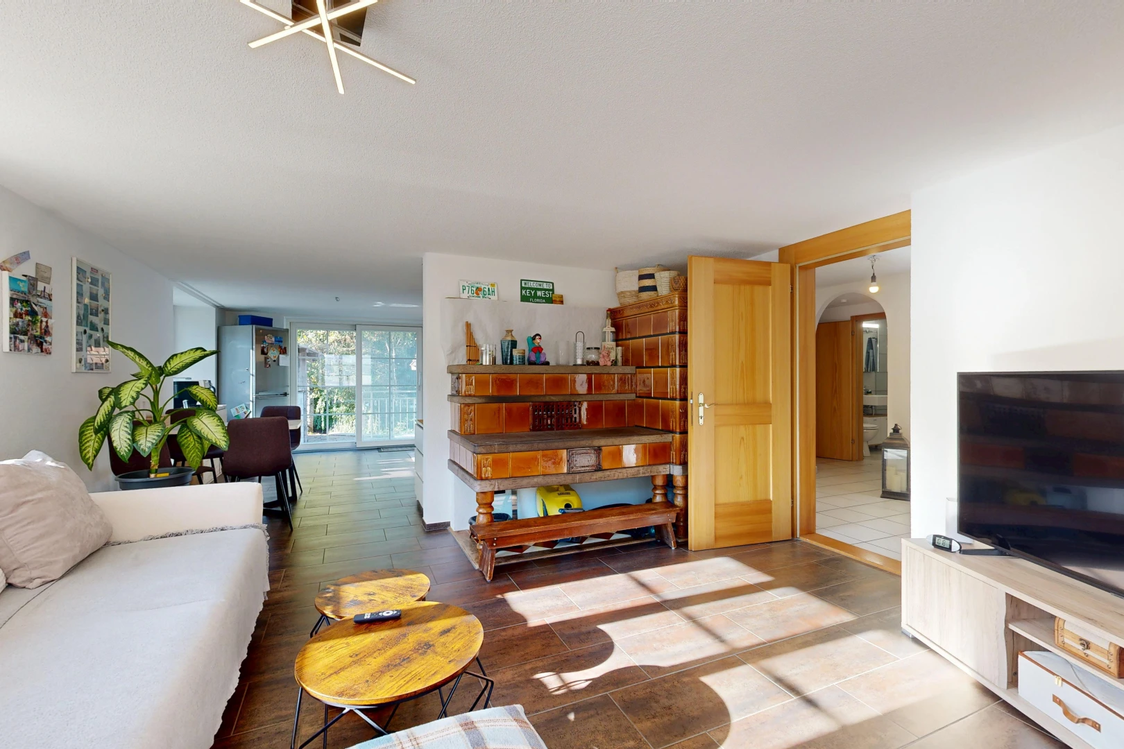 living area featuring arched walkways and access to exterior
