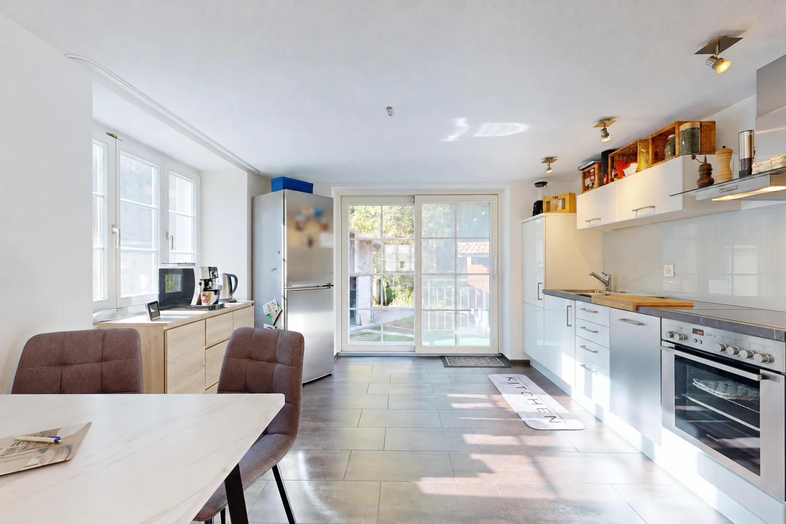 kitchen with stainless steel appliances, access to outside, extractor fan, and white cabinets