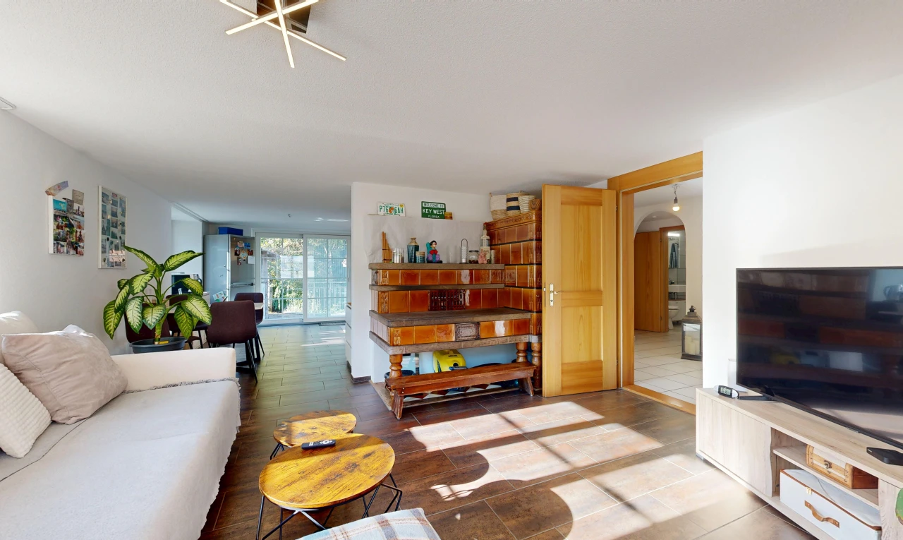 living area featuring arched walkways and access to exterior