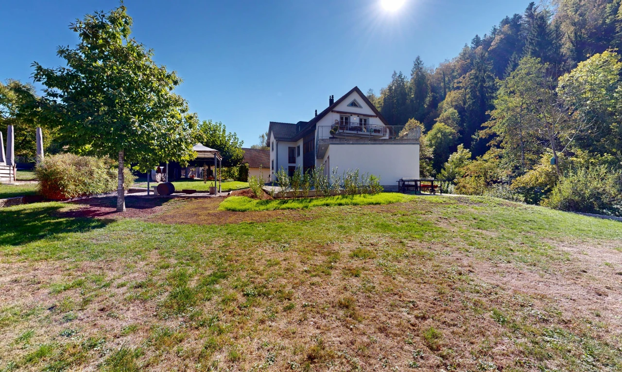 view of home with a yard and a balcony