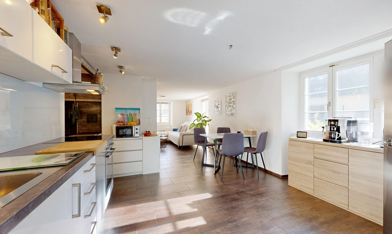 kitchen featuring plenty of natural light, modern cabinets, dark wood finished floors, and black microwave
