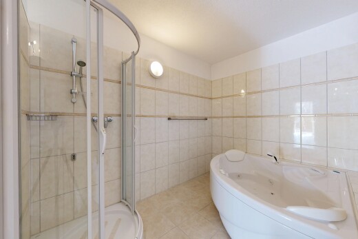 salle de bains avec tile wall, mur en carrelage, salle de bain complète, douche, et inside property